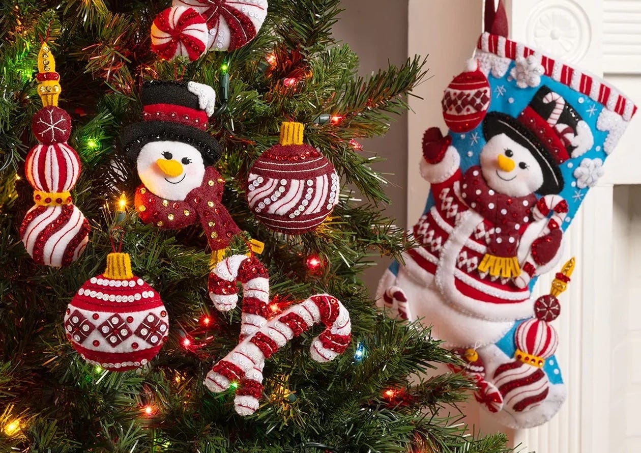 Bucilla felt ornaments and a snowman stocking on a Christmas tree.