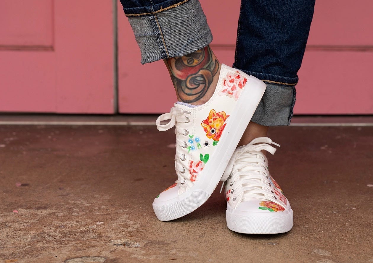 Custom white sneakers painted with colorful floral designs using Kicks Studio flexible shoe paint