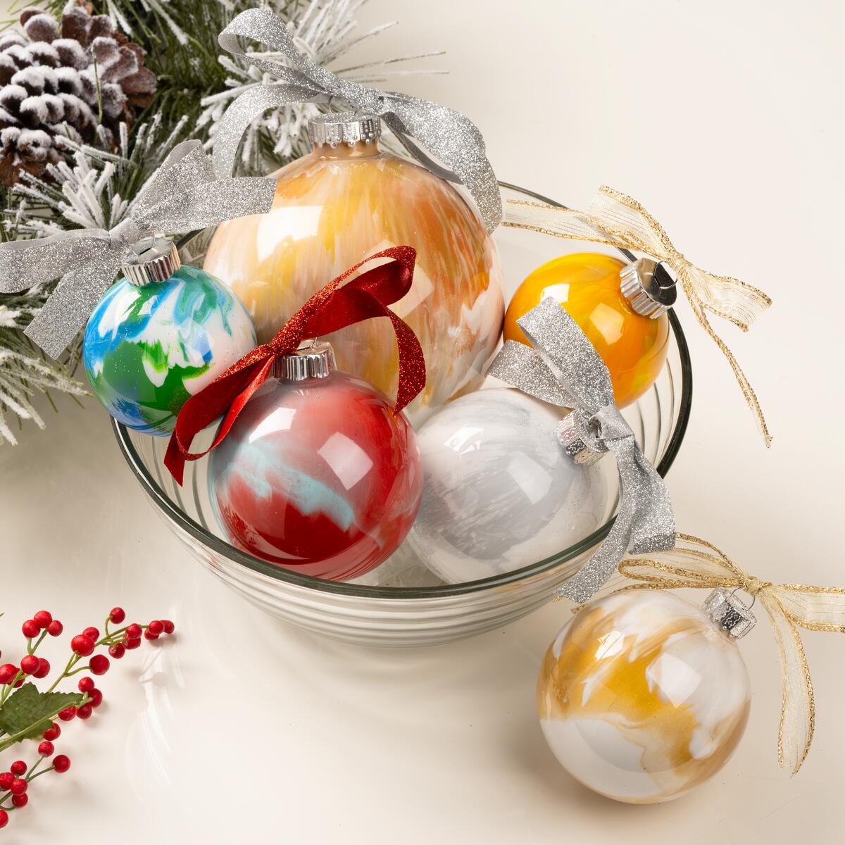 A glass bowl with paint swirled ornaments