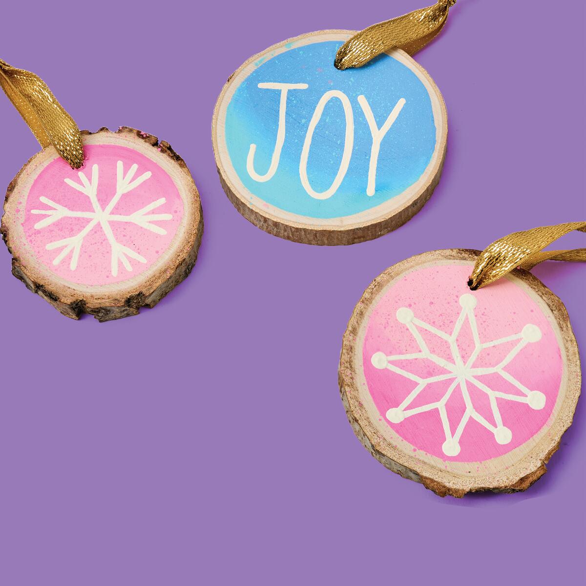 Create charming pastel hand-painted wood slice ornaments with our easy instructions! Perfect for adding a touch of whimsy to your decor. 