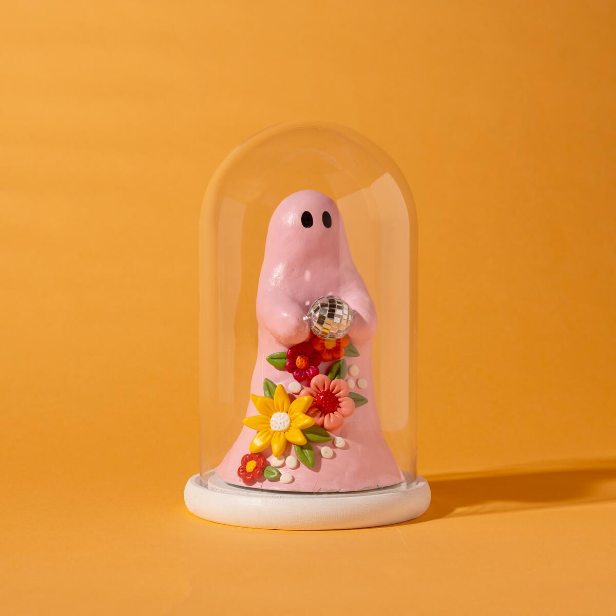 Air dry clay pink ghost in a glass cloche with flowers and a disco ball