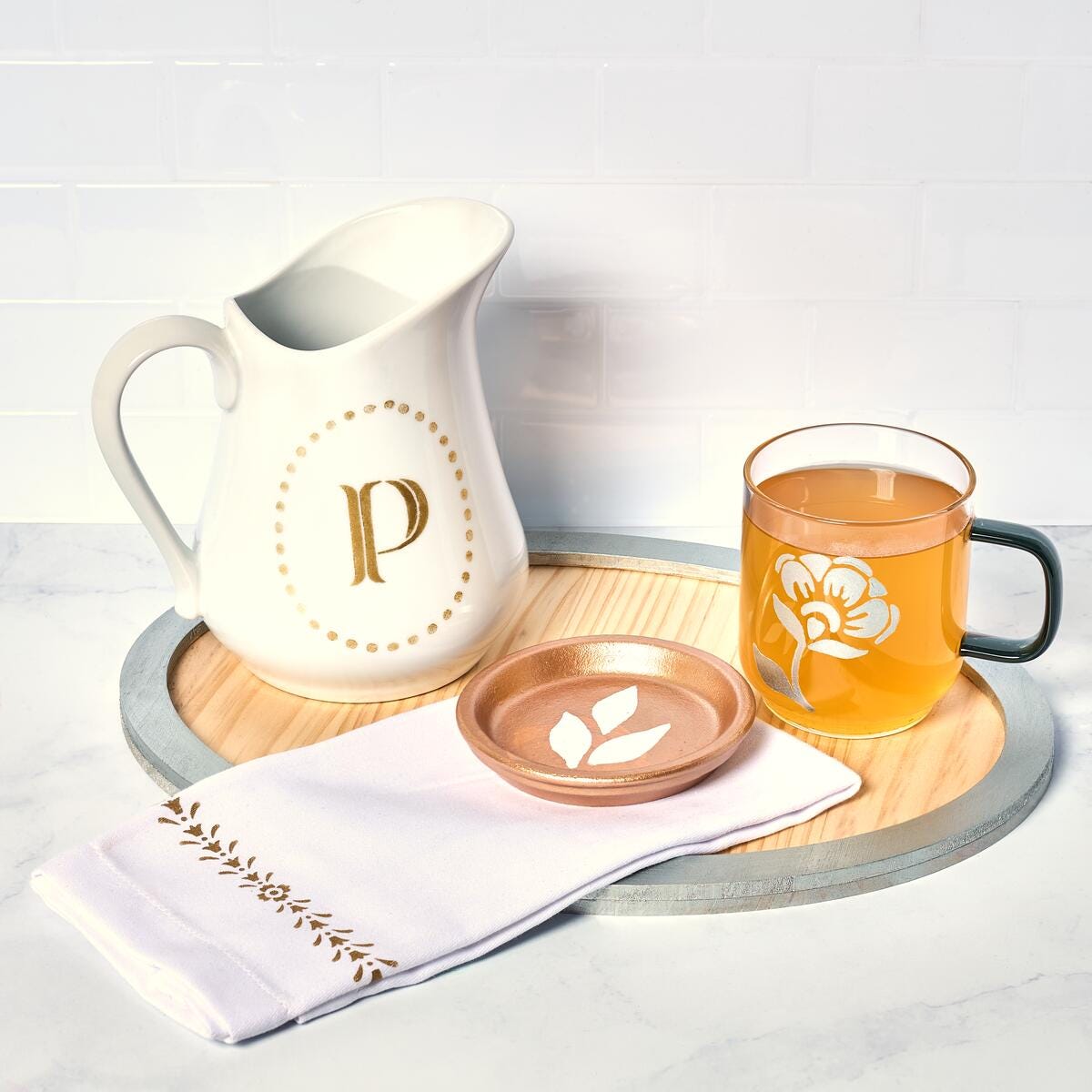 Glassware and a ceramic pitcher painted with Martha Stewart metallic paints