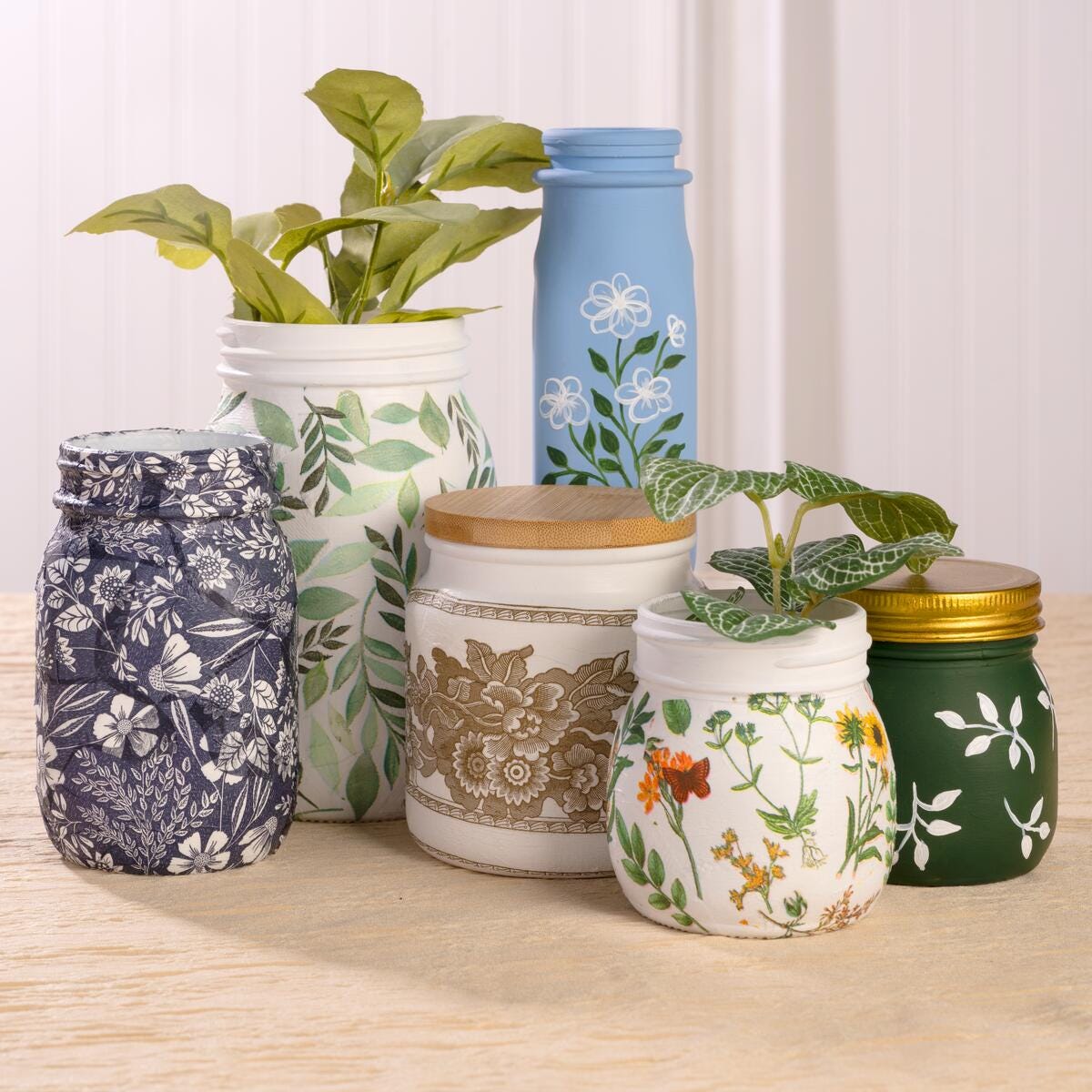 Decoupaged glass jars with floral patterns