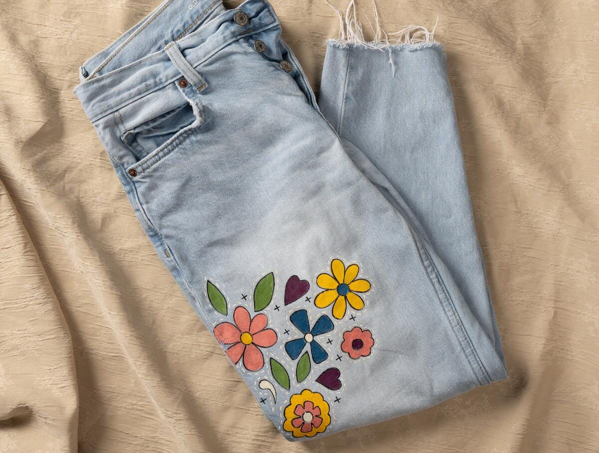 Jeans upcycled with hand-painted vintage floral design