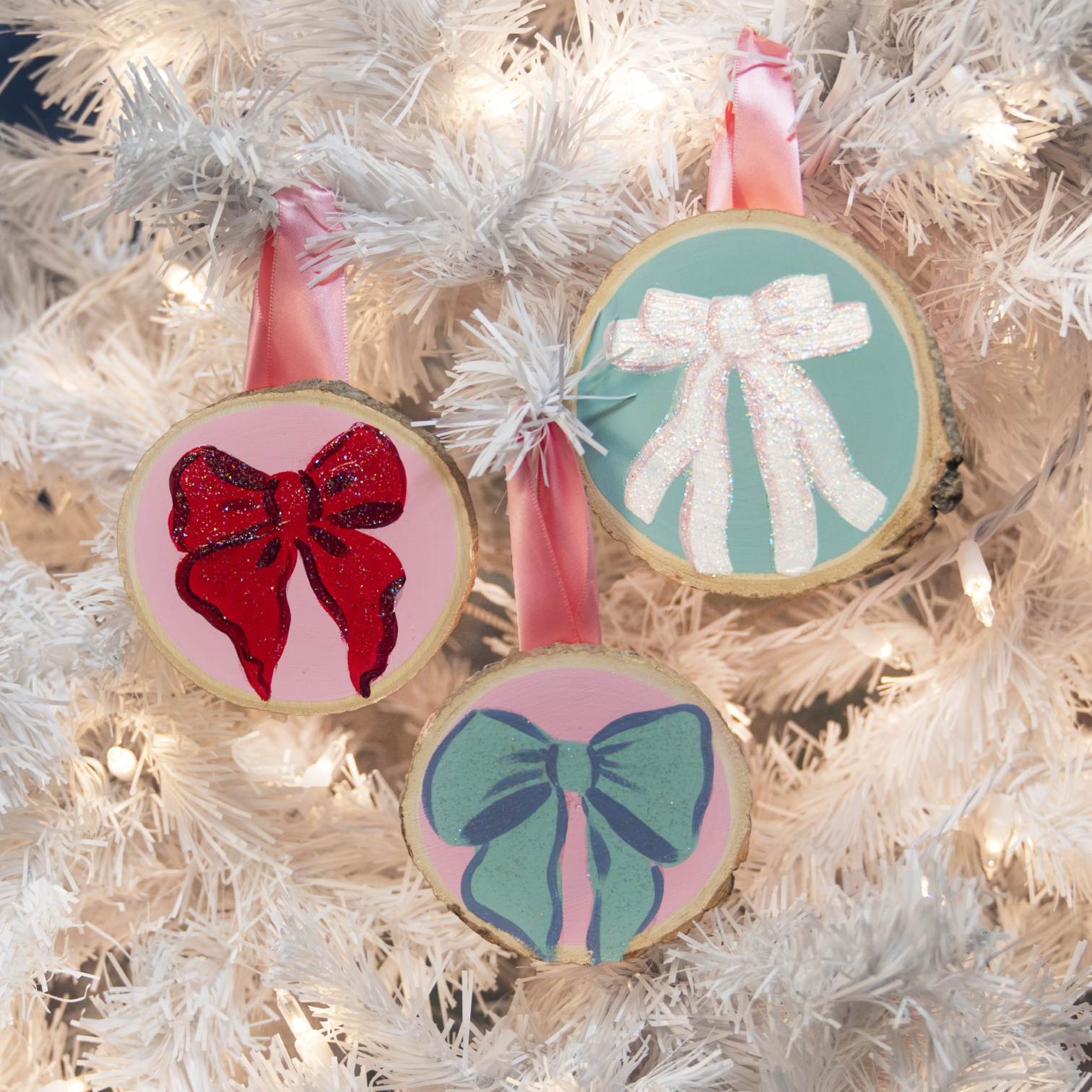 Wood round ornaments painted with colorful ribbons