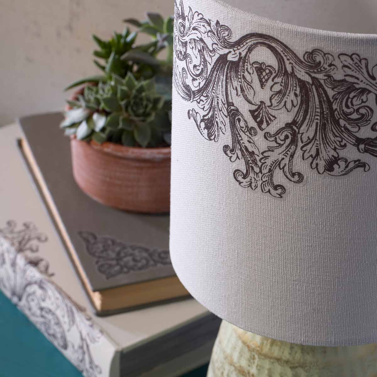 Ornate Lamp, Books, and Garden Pot 